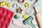 Flat lay or overhead view of baking tools and ingredients in pastel tones on a gray board