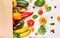 Flat lay paper shopping bag with assortment of fresh vegetables and fruits