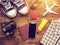 Flat lay of passport ,mobile, plane model , sneakers , wallet , camera and traveler`s accessories items