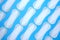 Flat lay pattern of clean unused sanitary woman pads on blue background