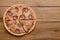 Flat lay pepperoni pizza  on rustic wooden background. Pizza salami cut in slices. Fast food, junk food concept.