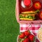 Flat lay. Picnic on the lawn with a veil, basket, sandwiches, strawberries, juice and fresh salad, healthy and tasty food, The