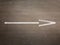 Flat lay picture of white arrow on a gray asphalt - Aerial drone top down view of white arrow on asphalt