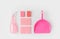 flat lay with pink washing sponges, bottle and scoop,