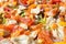 Flat lay pizza composition, tomatoes on wooden surface, close up macro