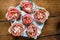 Flat lay sandwiches with bread, sausage, tomatoes, cheese and herbs on a white plate and wooden plank table during a quick bite or