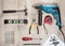 Flat lay Set of construction tools to repair on a wooden surface: drill, hammer, pliers, self-tapping screws, roulette