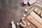 Flat lay a set of various bath and spa accessories. Terry towel, soap, comb, oil, shampoo, loofah washcloth, sea salt on a dark