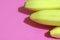 Flat lay of several yellow bananas on a pink background top view. Copy space for text