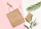 Flat Lay shopping concept with paper bag and tropical leaves. Elegant composition with elegant accessories.