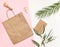 Flat Lay shopping concept with paper bag and tropical leaves. Elegant composition with elegant accessories.