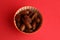 Flat lay shot of a bowl of dates on a red surface
