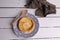 Flat lay shot of an egg tart and a wooden spoon on a plate and a towel on a table