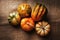 Flat lay shot of a group of autumn gourds, squash and pumpkins on burlap with warm side light