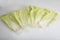  flat lay shot of a pile of Chinese napa cabbage leaves on a white background