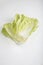  flat lay shot of a pile of Chinese napa cabbage leaves on a white background