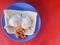 Flat lay shot a special breakfast of toast with half-put eggs and red beans on red background