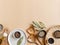 Flat lay of small bowls various dry spices, wood kitchen utensils, olive oil in glass bottle on a beige background. Top view