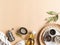 Flat lay of small bowls various dry spices, wood kitchen utensils, olive oil in glass bottle on beige background. Top view. copy