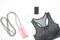 Flat lay of smartphone, sport bra and sport equipments on white