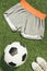 flat lay with soccer ball, sportswear and sneakers