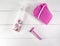 Flat lay spa bath on white wooden background, top view products for hygiene. Shaver, bast for a body and cosmetic tube