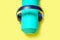Flat Lay Sport and fitness equipment, headphones and mint yoga mat listen music on yellow background. Top view