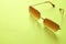 Flat lay  Square sunglasses isolate on a green background