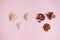 Flat lay still life with assortment of wholesome healthy organic raw seeds, nuts and beans isolated on pink background