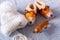 Flat lay still life with childhood objects including a tiger toy, a wooly hat and felt slippers