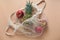 flat lay string bag with pineapple and red apples on a beige background