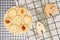 Flat lay of sweets, Danish butter cookie on rattan plate and model house on rack with gingham cloth