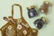 Flat lay of three glass jars with tea, wooden spoons and a reusable string bag on a mint background decorated with daisies.