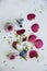 Flat lay top down view image of romantic vintage look of Spring and Summer flower petals and blooms still life on rustic old worn