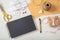 Flat lay and top view of black notebook and wedding invitations on a white wooden tabletop, copy space.