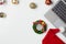 Flat lay top view Christmas office table desk party concept, Christmas workspace with laptop, Santa Claus hat and Christmas