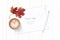 Flat lay top view elegant white composition paper botanic garden autumn maple leaf tag pencil and coffee on wooden background