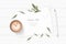Flat lay top view elegant white composition paper botanic garden plant leaf flower pine cone tag pencil and coffee on wooden