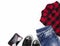 Flat lay Top view female style look with plaid t shirt, jeans, sneakers and wallet