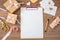 Flat lay and top view of notepad and wedding invitations on a wooden tabletop, copy space.