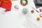 Flat lay top view office table desk, Christmas workspace with keyboard, Santa Claus hat and christmas decorations on white