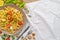 Flat lay top view pasta plate on white tablecloth with free space