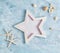 Flat lay top view Summer vacation mockup: star shaped photo frame, seashells and white starfish on blue background. Travel, beach