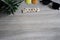 flat lay top view summer word written on wooden block with sunglasses, seashell and head of pine apple on vintage wooden