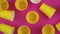 Flat lay top view of a yellow cups with pink background