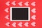 Flat lay of touchpad with blank screen on red background with paper cut hearts