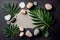 Flat lay tranquil wellness image featuring palm leaves and smooth stones