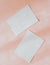 Flat lay of two blank cards sheet on aesthetic pastel pink background
