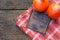 Flat lay, two hokkaido pumpkins and board on wooden table