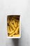 Flat lay of uncooked tortiglioni pasta shells in box